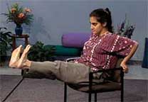 woman in chair kicks legs out in front of her